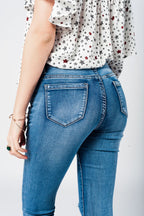 Skinny Jeans in Midwash with Busted Knees and Chewed Hems