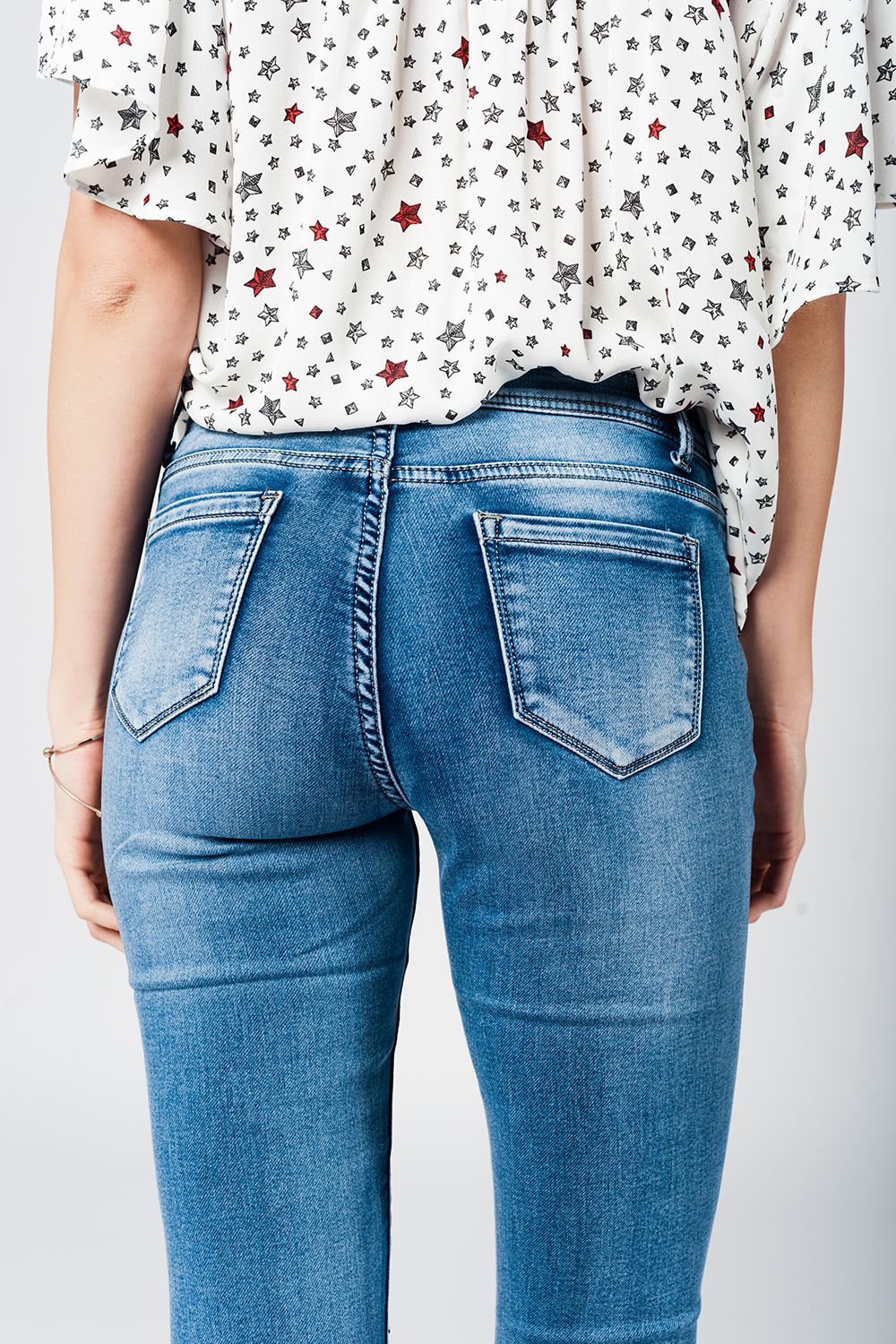 Skinny Jeans in Midwash with Busted Knees and Chewed Hems